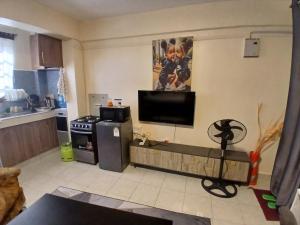 a living room with a flat screen tv on the wall at Maridadi place in Kakamega