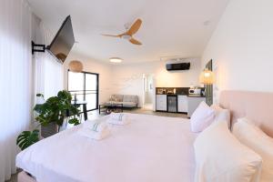 a bedroom with a large white bed with two pillows at ציפור הכנרת - סוויטה מבודדת נוף לכנרת in Had Nes +27 photos