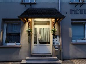 a front door of a house with flowers on it at Domaine Du Hêtre - Meublé T2 in Bains-les-Bains