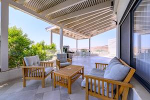 a patio with chairs and a table on a patio at ציפור הכנרת - סוויטה מבודדת נוף לכנרת in Had Nes