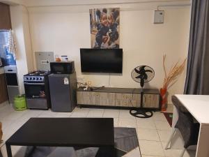 a living room with a flat screen tv on the wall at Maridadi place in Kakamega +14 photos