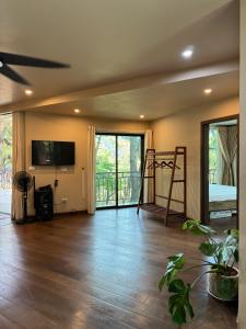 an empty living room with a bed and a television at DeBay Retreat - Little Đà Lạt Chill Villa in Sóc Sơn