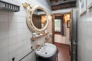 a bathroom with a sink and a mirror at La Casa del Grillo Parlante in Collodi +41 photos