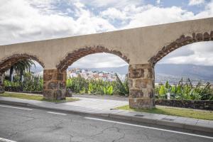 an old stone bridge with arches on a road at Apto Yurena 10B 2B in Los Llanos de Aridane