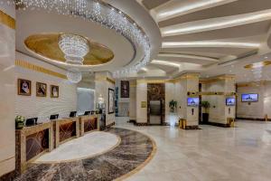 a lobby of a hotel with a chandelier at Makkah Hotel in Mecca