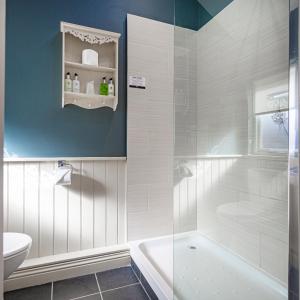 a bathroom with a tub and a toilet and a sink at The Feathers Hotel, Helmsley, North Yorkshire - The Coaching Inn Group in Helmsley