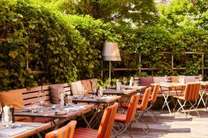 a group of tables and chairs in a garden at Gastwerk Hotel Hamburg in Hamburg