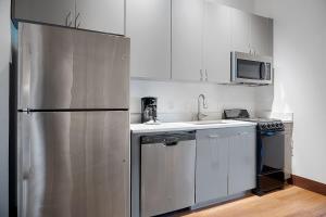 a kitchen with a stainless steel refrigerator and a microwave at Cute Little Condo no 310 in Dallas