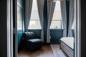 a bedroom with a chair and a bed and a window at Cute Little Condo no 310 in Dallas