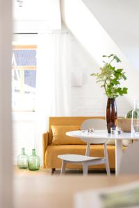 a living room with a couch and a table at Hotel Bleibe in Freudenberg am Main