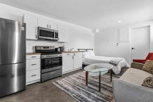 a kitchen and living room with a stainless steel refrigerator at Lakeside Haven suite in Georgina +4 photos