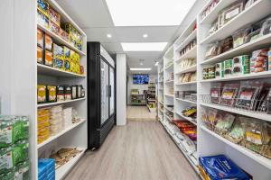 a aisle of a store with shelves of food at Lakeside Haven suite in Georgina
