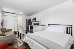 a bedroom with a large bed and a kitchen at Lakeside Haven suite in Georgina