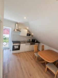 a kitchen and dining room with a wooden table at Monteur Zimmer Künzing in Künzing