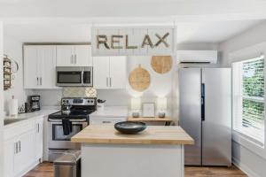 a kitchen with white cabinets and a stainless steel refrigerator at Pasture Bedtime in Franklin