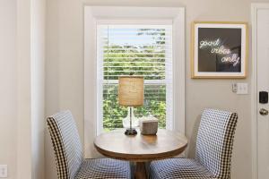 a dining room with a table and two chairs and a window at Pasture Bedtime in Franklin