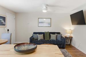 a living room with a couch and a table at Pasture Bedtime in Franklin
