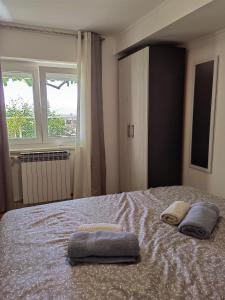 a bedroom with a bed with two towels on it at Apartman Aurora in Ičići