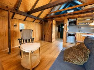 a room with a table and a chair in a cabin at Traditional Cabin with Sea View in Stykkið