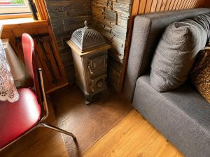 a living room with a couch and a table at Traditional Cabin with Sea View in Stykkið
