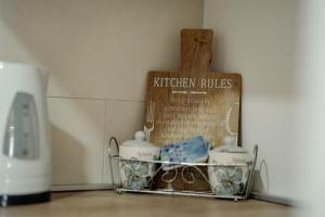 a shelf with a tray of kitchen dishes and a sign at Ohrid Pearl Apartment in Ohrid +37 photos