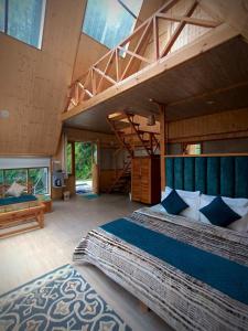 a large room with two beds and a staircase at jibhihomesteadcabin in Jibhi