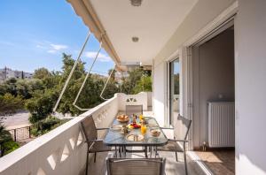 a balcony with a table with food on it at City Center Calm Spot in Athens