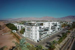 an aerial view of a large white apartment building at Royal Park Apartments Resort by Sea N Rent in Eilat