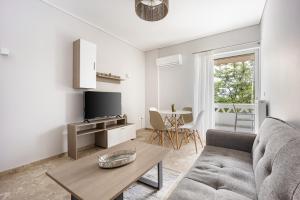 a living room with a couch and a table at City Center Calm Spot in Athens