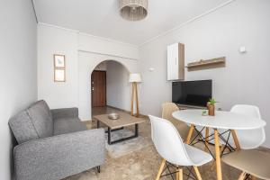 a living room with a couch and a table at City Center Calm Spot in Athens +8 photos