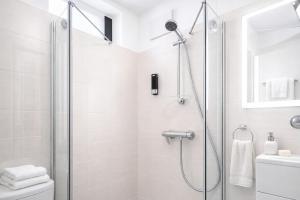 a shower with a glass door in a bathroom at APSTAY central station I Self Check-in I Parking option in Graz