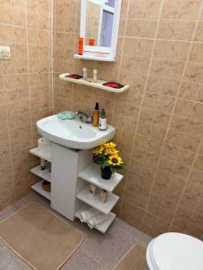 a bathroom with a white sink and a mirror at Maison front de mer in El Jadida +5 photos