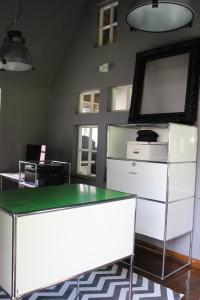 an office with a glass table and a mirror at Eifel-Quartiere "Pension Müscher Bahnhof" in Müsch
