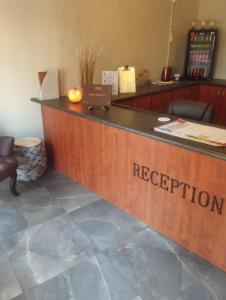 a reception desk with the name of a reception desk at Nguni Gaste Huis in Mooinooi +63 photos