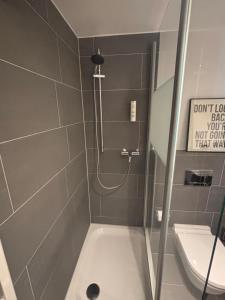 a small bathroom with a shower and a toilet at MY STAY - Smart Hotel in Mönchengladbach
