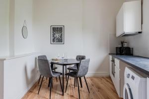 a kitchen with a table and chairs in a room at Potsdam Classic Apartment in Potsdam
