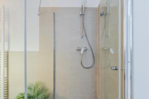 a bathroom with a shower with a glass door at Potsdam Classic Apartment in Potsdam
