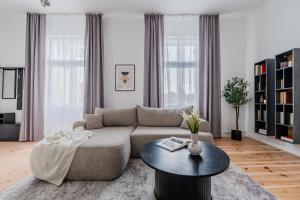 a living room with a couch and a table at Potsdam Classic Apartment in Potsdam