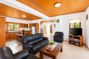 a living room with a couch and a table at Villa Androulla in Argaka