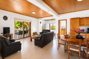 a living room with a table and chairs and a dining room at Villa Androulla in Argaka