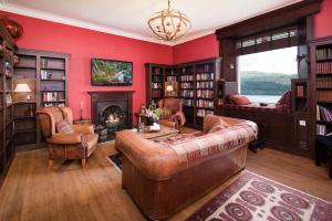 a living room with a couch and a fireplace at Stucktaymore in Killin