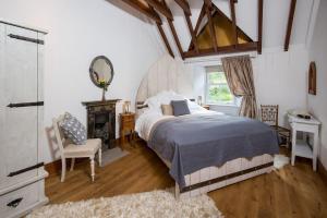 a bedroom with a bed and a chair and a window at Stucktaymore in Killin