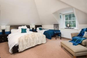 a bedroom with a large bed and a chair at Stuckgowan in Arrochar