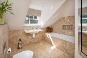 a bathroom with a sink and a bath tub at Stuckgowan in Arrochar +23 photos