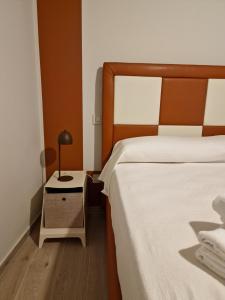 a bedroom with two beds and a lamp on a night stand at marte rooms in Centola
