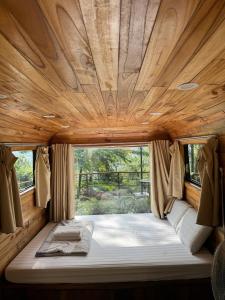 a bed in the back of a rv with a wooden ceiling at DeBay Retreat - Little Đà Lạt Chill Villa in Sóc Sơn +129 photos