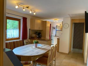 a kitchen and dining room with a table and chairs at Gästehaus Judith in Längenfeld