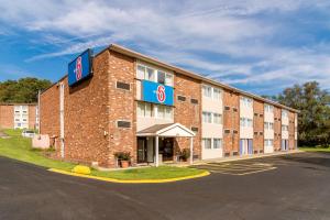 a hotel with a sign on the side of a building at Motel 6-New Stanton, PA in New Stanton