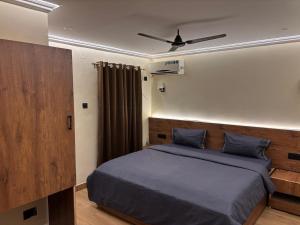 a bedroom with a bed and a ceiling fan at Aariv Inn BAGA BEACH in Baga