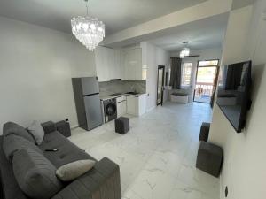a living room with a couch and a kitchen at MM House in Yerevan